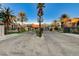 View of the gated community entrance with palm trees and well-maintained landscaping at 1700 Brock Ct, Las Vegas, NV 89117