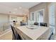 Bright dining area with a granite table, shuttered windows, and access to the kitchen at 1700 Brock Ct, Las Vegas, NV 89117