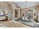 Formal dining area with elegant lighting, stylish furnishings, and an adjacent living space at 1700 Brock Ct, Las Vegas, NV 89117