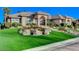 Beautiful exterior elevation with manicured lawn, mature landscaping, and an inviting entrance at 1700 Brock Ct, Las Vegas, NV 89117