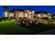Charming home featuring well-manicured front yard, rock landscaping, and warm exterior lighting at dusk at 1700 Brock Ct, Las Vegas, NV 89117