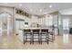 Spacious kitchen with a central island, bar seating, white cabinets, and modern appliances at 1700 Brock Ct, Las Vegas, NV 89117