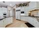 Bright, open kitchen with granite countertops, white cabinetry, and modern appliances at 1700 Brock Ct, Las Vegas, NV 89117