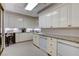 Well-lit laundry room featuring ample cabinet space, granite countertops, and modern appliances for convenience at 1700 Brock Ct, Las Vegas, NV 89117