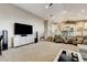 Bright living room with a modern entertainment system and an open floor plan to the kitchen at 1700 Brock Ct, Las Vegas, NV 89117