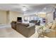 Large carpeted living room has multiple seating areas, and sliding glass door to backyard at 1700 Brock Ct, Las Vegas, NV 89117