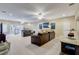 Spacious carpeted living room with comfortable furniture, ceiling fans, and plenty of space for entertaining at 1700 Brock Ct, Las Vegas, NV 89117