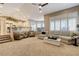 Open-concept living room with plush seating, carpet flooring, and access to the kitchen at 1700 Brock Ct, Las Vegas, NV 89117