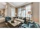 Bright living room featuring elegant furniture, neutral tones, and ample natural light through shuttered windows at 1700 Brock Ct, Las Vegas, NV 89117