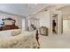 A spacious main bedroom showcases a sitting area, walk-in closet, and neutral walls and carpet at 1700 Brock Ct, Las Vegas, NV 89117