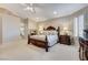 A lavish main bedroom features a decorative bed frame, neutral carpeting, and natural light at 1700 Brock Ct, Las Vegas, NV 89117