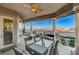 Covered outdoor patio with seating, a ceiling fan, and views of the surrounding landscape at 1700 Brock Ct, Las Vegas, NV 89117