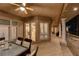 Covered patio with outdoor seating, white pillars, and natural light from the patio doors at 1700 Brock Ct, Las Vegas, NV 89117