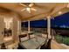 Inviting covered patio featuring a dining table, comfortable seating, and views of the city skyline at 1700 Brock Ct, Las Vegas, NV 89117