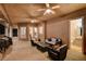 Spacious covered patio with comfortable seating, ceiling fans, grill, and access to an outdoor bathroom at 1700 Brock Ct, Las Vegas, NV 89117
