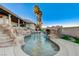 Resort-style pool featuring rock waterfall elements and well-maintained artificial turf at 1700 Brock Ct, Las Vegas, NV 89117