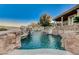 Backyard featuring a custom pool with rock features, spa, and a water slide at 1700 Brock Ct, Las Vegas, NV 89117