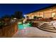 Beautiful backyard pool with slide, spa and waterfall feature, plus covered patio at 1700 Brock Ct, Las Vegas, NV 89117