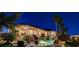 Backyard pool with rock features and waterfall, outdoor seating and covered porch with lighting at 1700 Brock Ct, Las Vegas, NV 89117