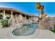 Backyard showcasing a custom pool with rock features and a beautifully landscaped yard at 1700 Brock Ct, Las Vegas, NV 89117
