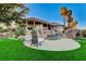 Backyard showcasing a custom pool with rock features and a beautifully landscaped yard at 1700 Brock Ct, Las Vegas, NV 89117
