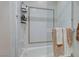 Bright bathroom featuring a shower and tub with decorative tiling and glass door at 1700 Brock Ct, Las Vegas, NV 89117