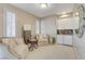 Cozy sitting room featuring two armchairs, accent tables, a wet bar, and shutters at 1700 Brock Ct, Las Vegas, NV 89117