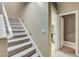 Carpeted staircase with white railing leading to the upper level, next to an open doorway at 1700 Brock Ct, Las Vegas, NV 89117