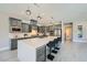 Open kitchen featuring a large island with seating, stainless steel appliances, and sleek cabinetry at 1939 Orchard Mist St, Las Vegas, NV 89135