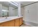 A well-lit bathroom with a shower-tub combination and double sink vanity at 23 E Agate Ave # 303, Las Vegas, NV 89123