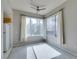 Bright bedroom featuring large windows with curtains and a ceiling fan for added comfort at 23 E Agate Ave # 303, Las Vegas, NV 89123
