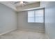 A tranquil bedroom with a ceiling fan and bright natural light coming through the window at 23 E Agate Ave # 303, Las Vegas, NV 89123