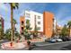 Modern building exterior with stucco and private terraces, surrounded by mature landscaping and convenient parking at 23 E Agate Ave # 303, Las Vegas, NV 89123