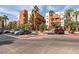 Beautifully landscaped building exterior with colorful accents, mature palm trees, and convenient parking spaces at 23 E Agate Ave # 303, Las Vegas, NV 89123