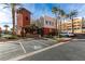 Attractive building exterior with palm trees, manicured landscaping, and a designated handicap parking space at 23 E Agate Ave # 303, Las Vegas, NV 89123