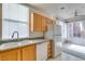Bright kitchen featuring granite counters, double sinks, wood cabinets and modern white appliances at 23 E Agate Ave # 303, Las Vegas, NV 89123