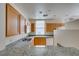 Kitchen featuring granite counters, double sinks, natural wood cabinets and modern appliances at 23 E Agate Ave # 303, Las Vegas, NV 89123
