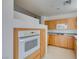 A well-equipped kitchen featuring granite counters, natural wood cabinets and modern appliances at 23 E Agate Ave # 303, Las Vegas, NV 89123