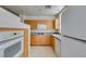Kitchen featuring granite counters, double sinks, natural wood cabinets and modern appliances at 23 E Agate Ave # 303, Las Vegas, NV 89123