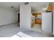 Bright living room with neutral walls and carpet, flowing into a functional kitchen space at 23 E Agate Ave # 303, Las Vegas, NV 89123