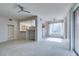 Spacious living area with light gray walls and carpet, seamlessly connected to the kitchen at 23 E Agate Ave # 303, Las Vegas, NV 89123