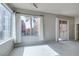 Bright living room features a large window with palm tree views and a sliding glass door at 23 E Agate Ave # 303, Las Vegas, NV 89123