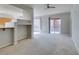 Open-concept living room features neutral walls, carpet, and view of the kitchen area at 23 E Agate Ave # 303, Las Vegas, NV 89123