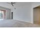 Neutral living room with plush carpet, opening to balcony, showcasing a modern, spacious layout at 23 E Agate Ave # 303, Las Vegas, NV 89123