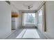 Bright living room with natural light, ceiling fan, and an adjacent kitchen area at 23 E Agate Ave # 303, Las Vegas, NV 89123