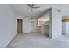 Open living room with neutral walls, carpet, and partial view of kitchen and closets at 23 E Agate Ave # 303, Las Vegas, NV 89123