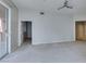 Expansive living room with neutral walls, carpet, and a sliding glass door to the outside at 23 E Agate Ave # 303, Las Vegas, NV 89123