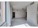 Spacious living room with light gray walls, neutral carpet, and multiple entryways at 23 E Agate Ave # 303, Las Vegas, NV 89123