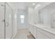 Bright bathroom with double sinks and a large mirror with a shower at 234 Walsh Peak Ave, Henderson, NV 89015