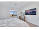 Bright bedroom with natural light and a modern aesthetic, showcasing a comfortable bed and stylish dresser at 234 Walsh Peak Ave, Henderson, NV 89015